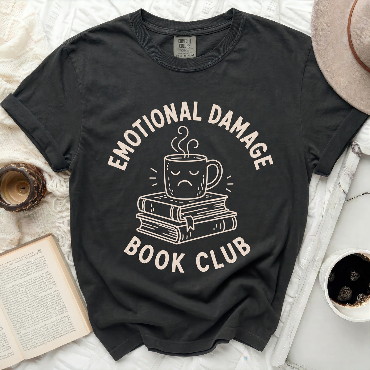 Dark t-shirt with "Emotional Damage Book Club" and a sad coffee cup graphic.
