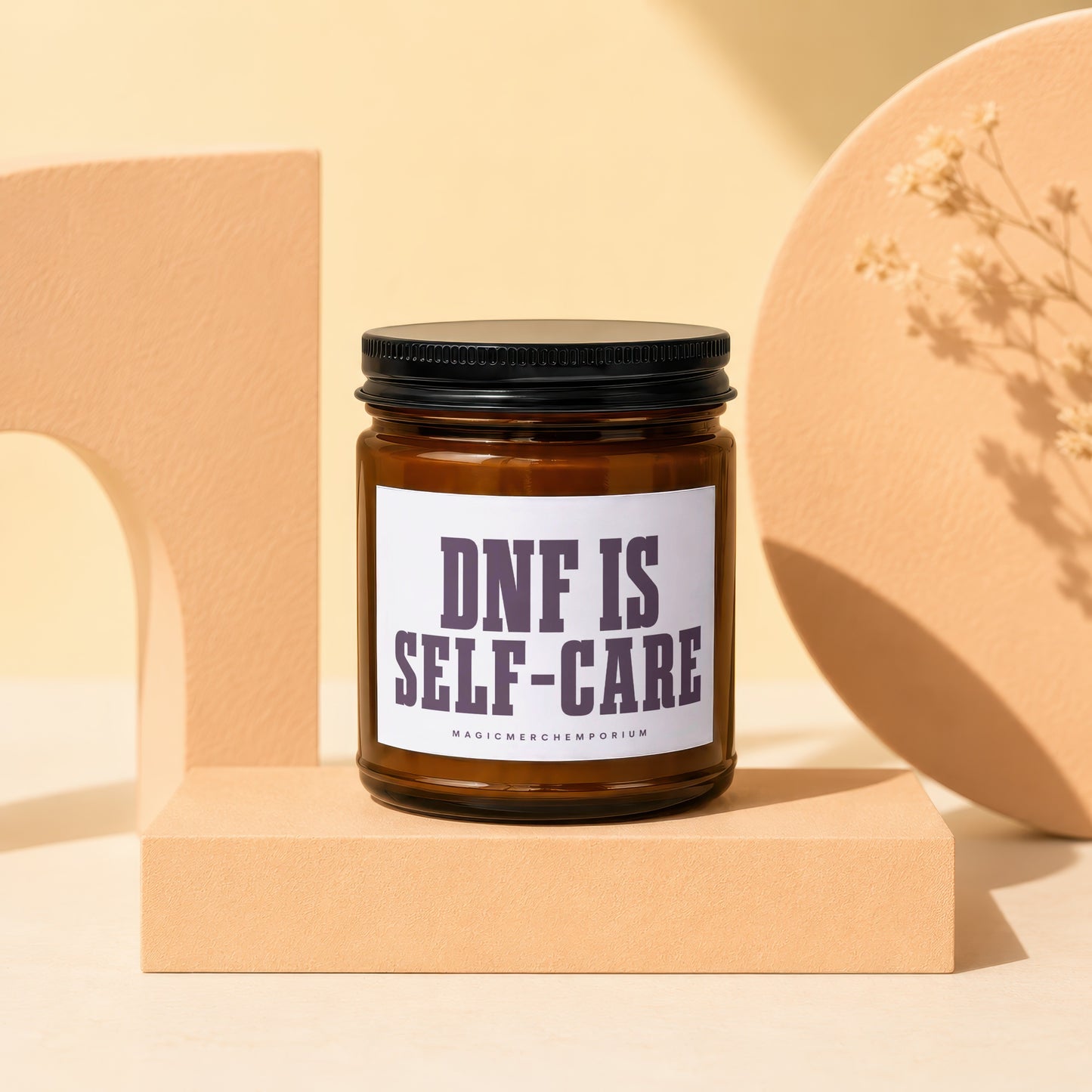 Amber jar candle with black lid reading "DNF IS SELF-CARE".