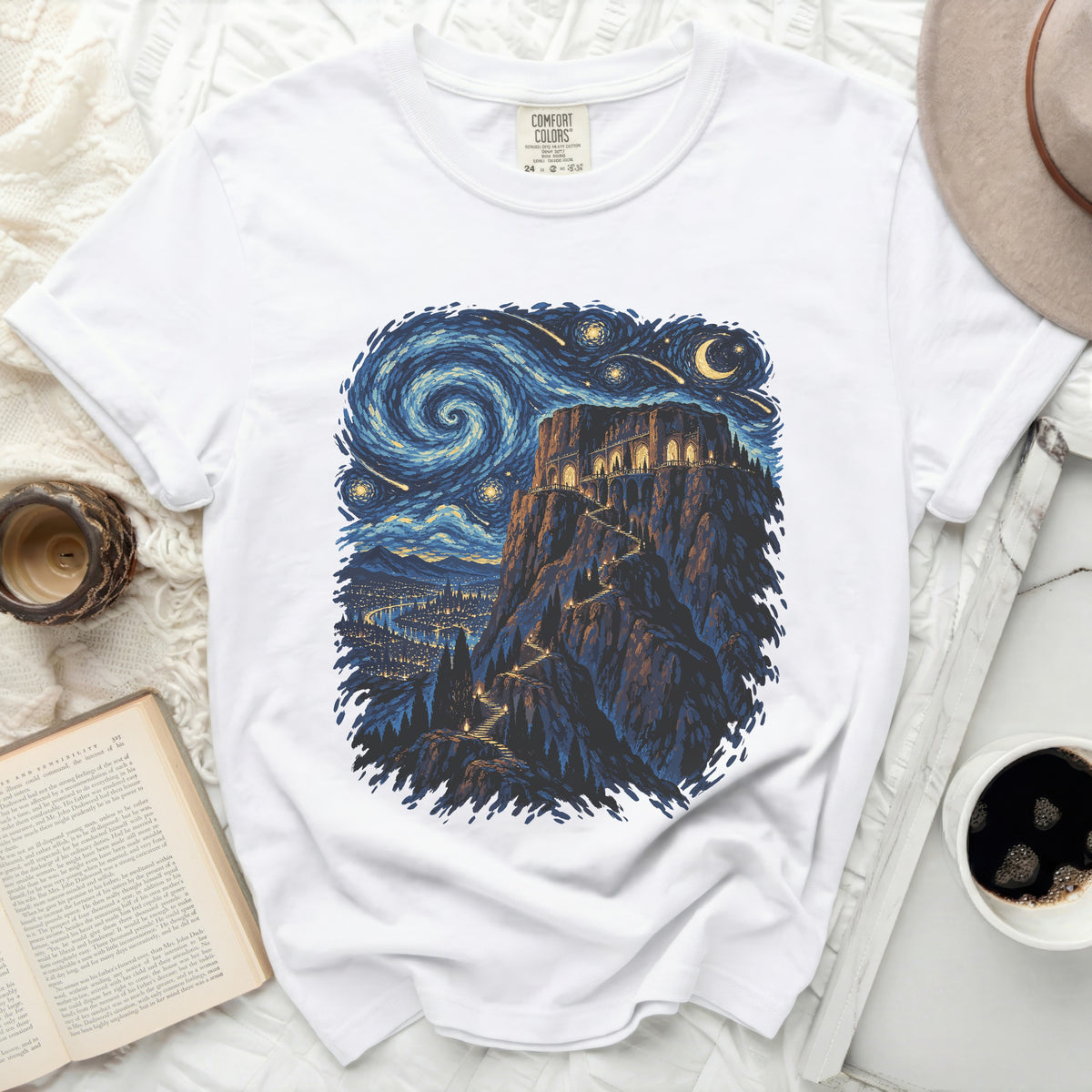 White t-shirt with a starry night and castle illustration.