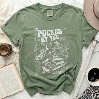 Green t-shirt with "Pucked by You" bookish romance graphic and text.