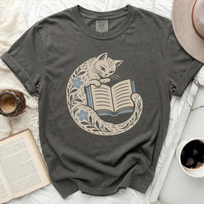 Dark grey t-shirt with a cream cat reading a book, surrounded by blue flowers.