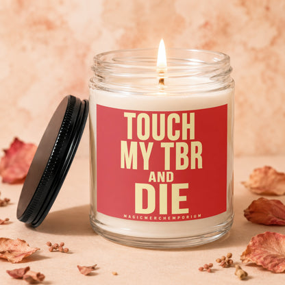 Candle with text "TOUCH MY TBR AND DIE" and "MAGICMERCH" on label.