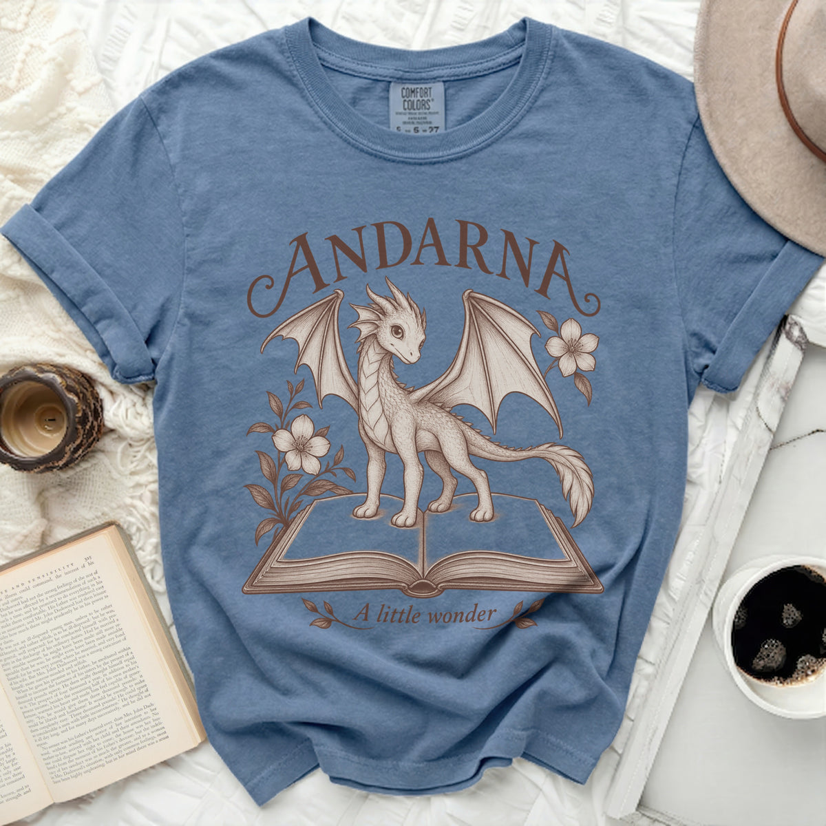 Blue t-shirt with "ANDARNA A little wonder" text and a dragon illustration.