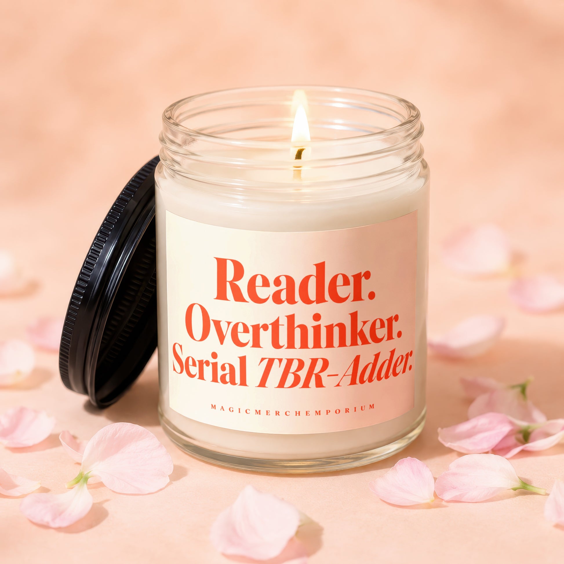 Candle with lid ajar, reading "Reader. Overthinker. Serial TBR-Adder.".