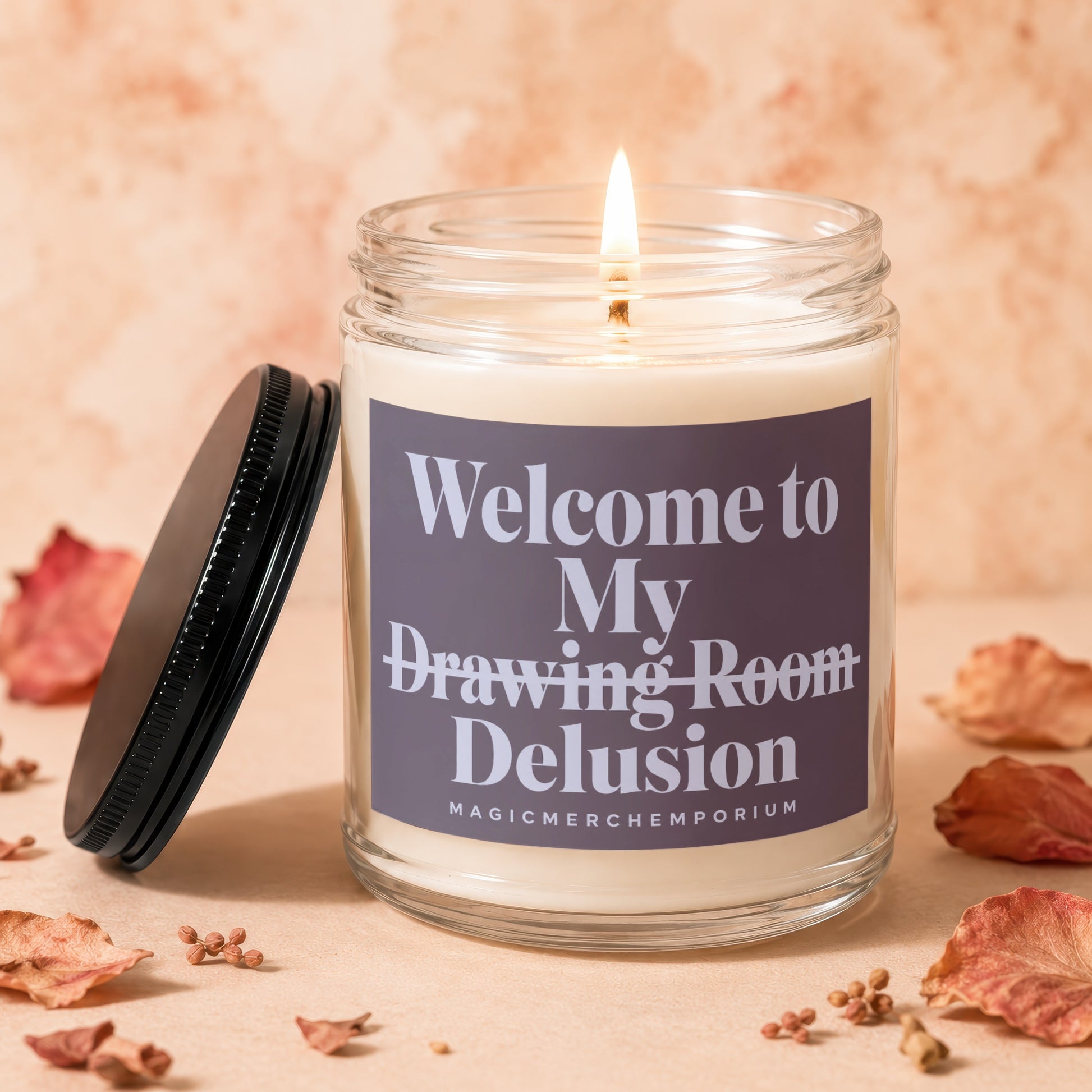 Candle with lit wick and lid askew, reading "Welcome to My Drawing Room Delusion."