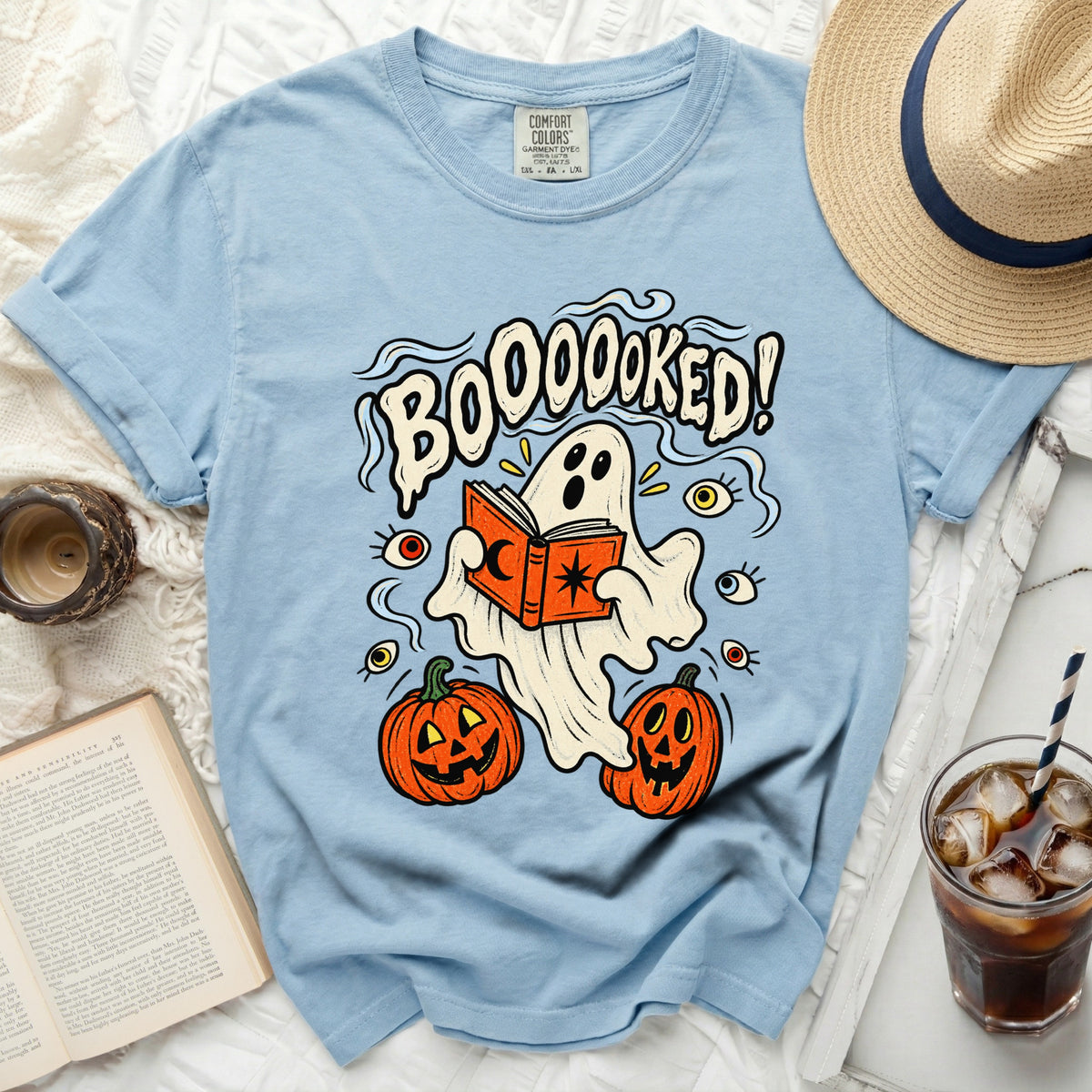 Light blue t-shirt with a ghost reading a book and "BOOOOOKED!" text.