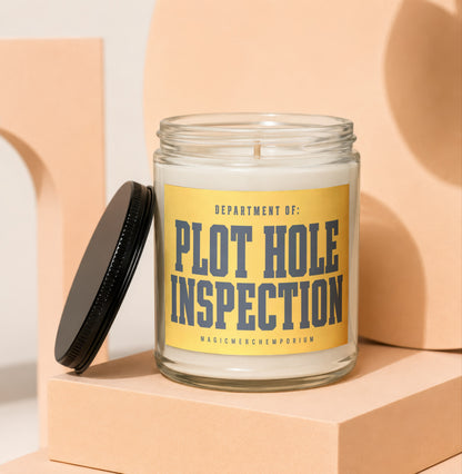 Glass candle with yellow label reading "DEPARTMENT OF: PLOT HOLE INSPECTION".