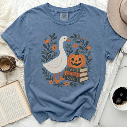 Blue Comfort Colors t-shirt with a white goose, pumpkin, and floral design.