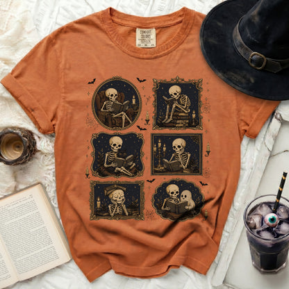 Orange t-shirt with five framed illustrations of skeletons reading.