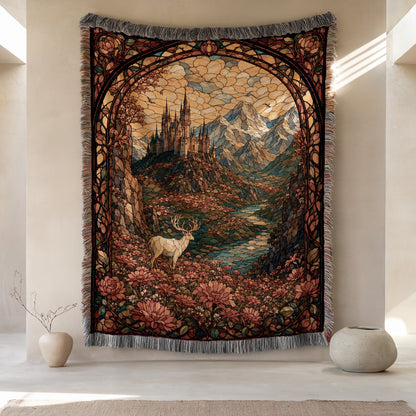 a large tapestry hanging on a wall, depicting a serene landscape with a castle, mountains, and a deer in the foreground. The tapestry is framed by an ornate border and has a vibrant color palette, creating a visually striking and detailed scene.