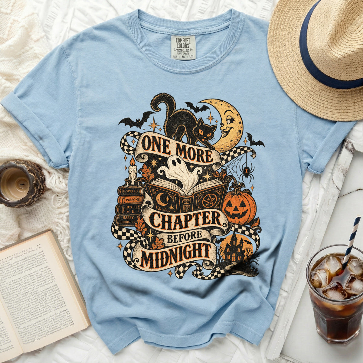 Light blue t-shirt with a Halloween graphic that reads "One More Chapter Before Midnight".