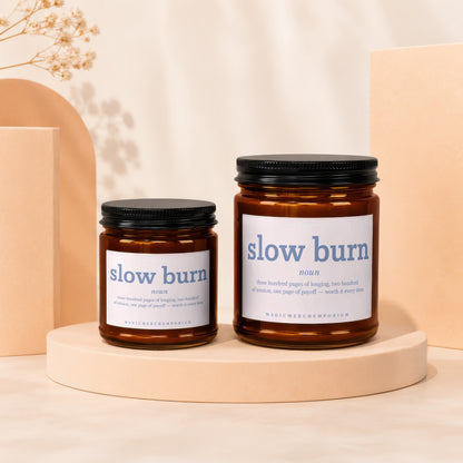 Two amber jar candles labeled "slow burn" with descriptive text and brand name.