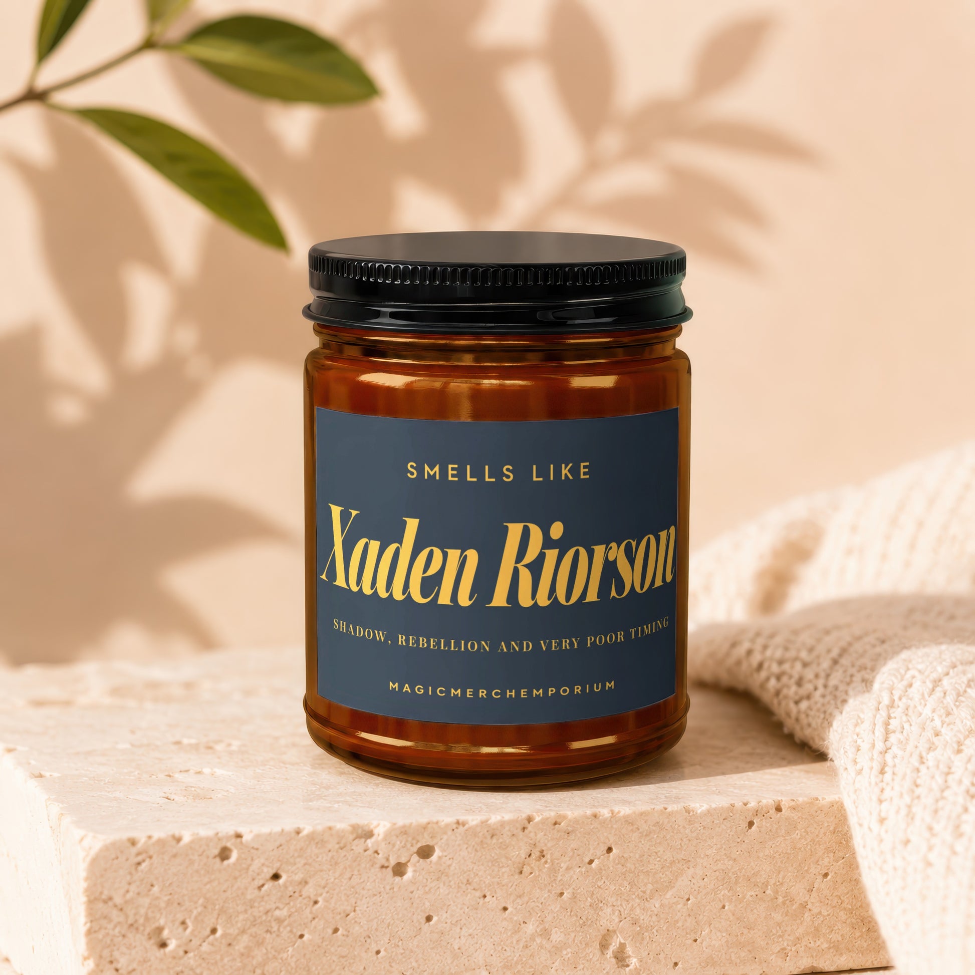 Candle labeled "Xaden Riorson" with scents "Shadow, Rebellion, and Very Poor Timing."
