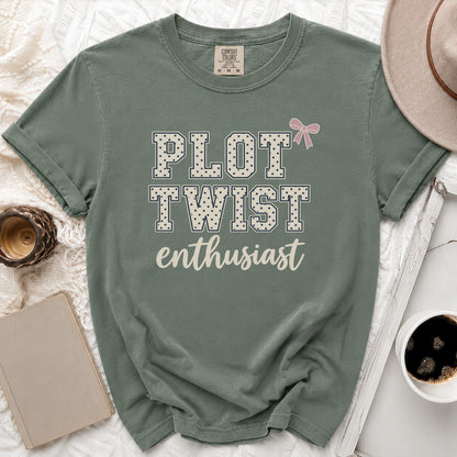 Green t-shirt with "Plot Twist Enthusiast" text and a pink bow.