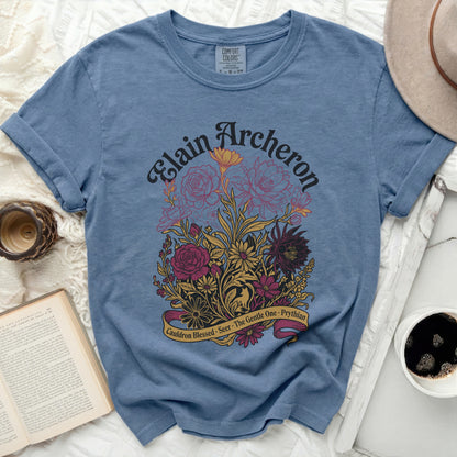 Blue t-shirt with Elain Archeron floral design and banner text.
