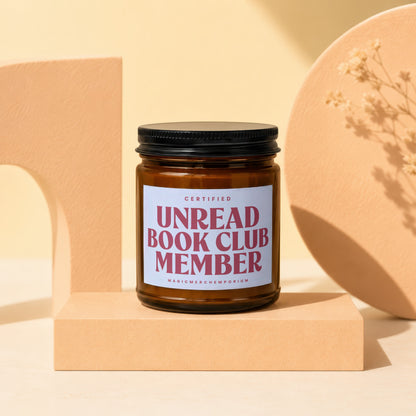 Amber jar candle with "Certified Unread Book Club Member" label.