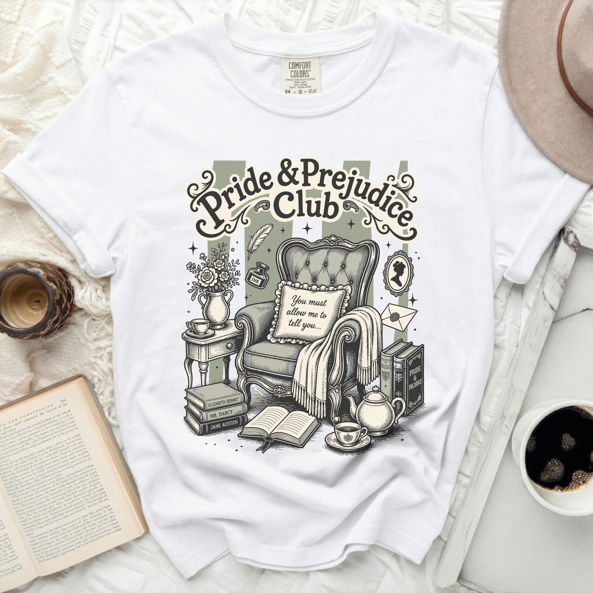 White t-shirt with Pride & Prejudice Club graphic featuring armchair and books.