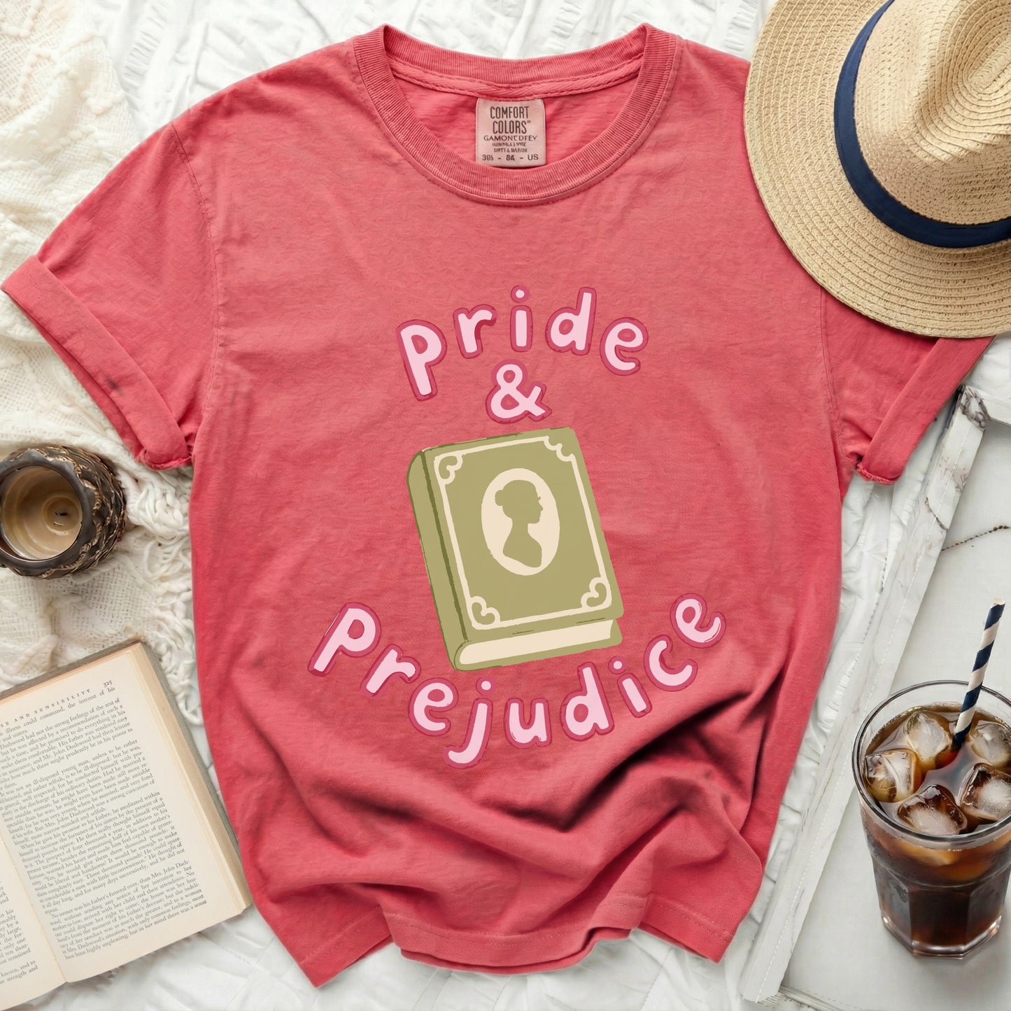 Coral t-shirt with "Pride & Prejudice" text and a book graphic.