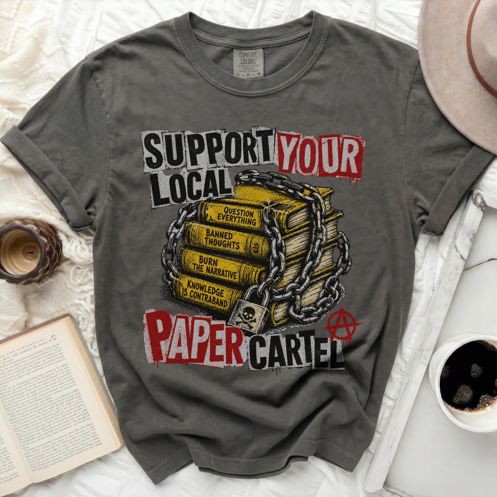 T-shirt with "SUPPORT YOUR LOCAL PAPER CARTEL" text and chained books graphic.