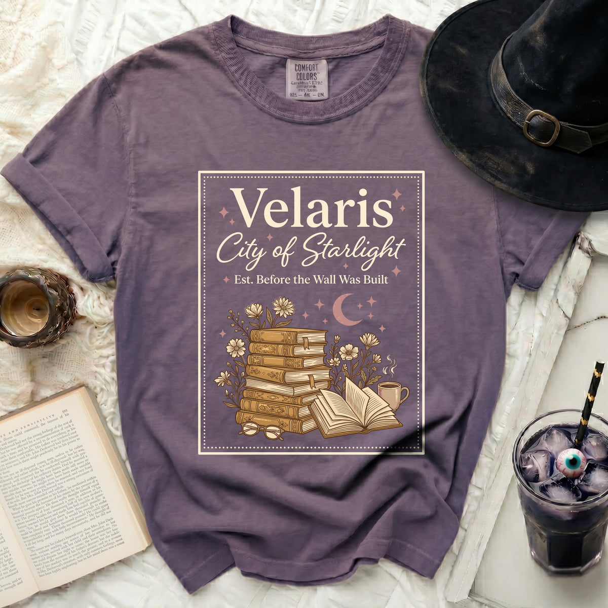Velaris City of Starlight graphic tee with stack of books and flowers.