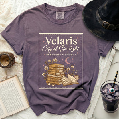 Velaris City of Starlight graphic tee with stack of books and flowers.