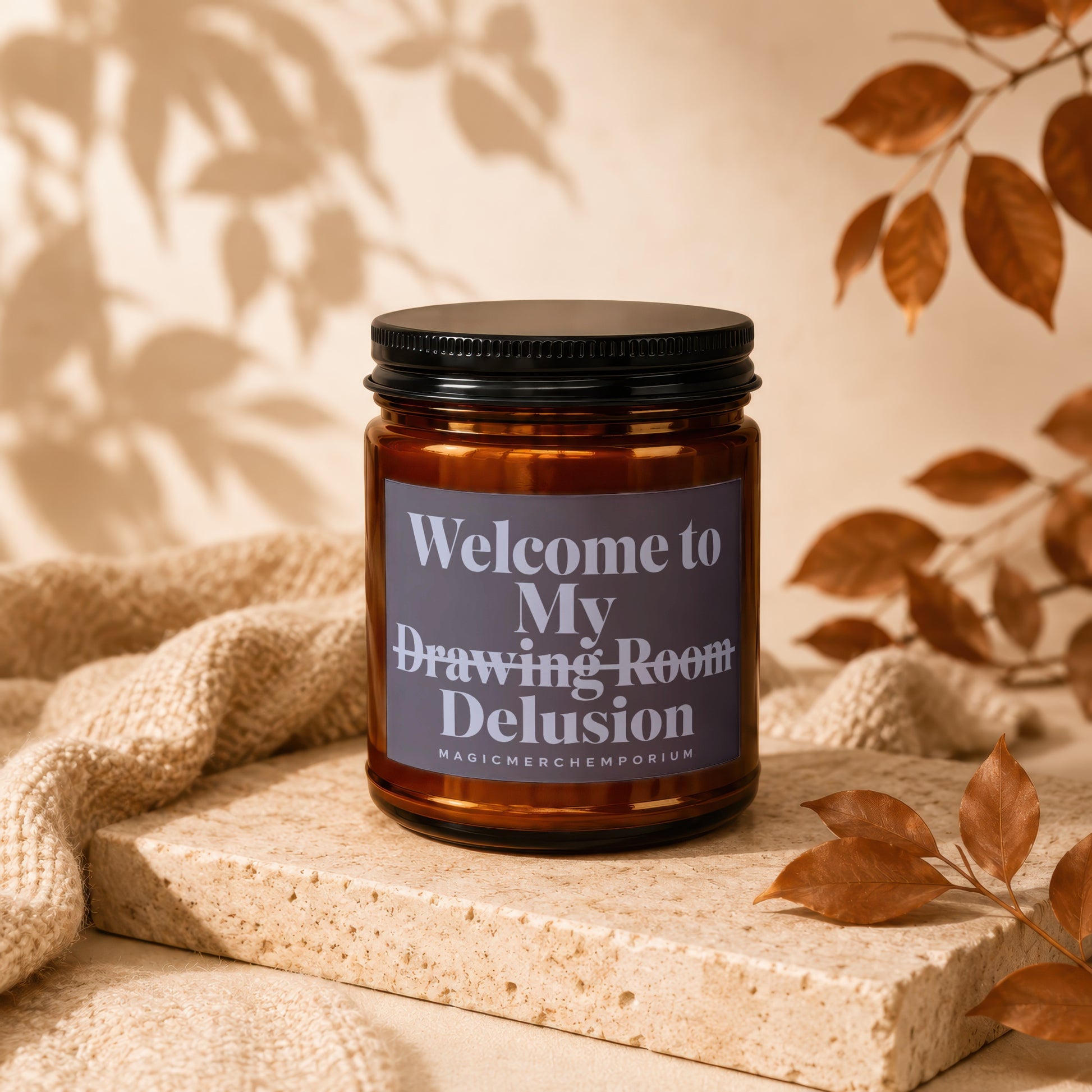 Amber candle with black lid and label reading "Welcome to My Drawing Room Delusion".