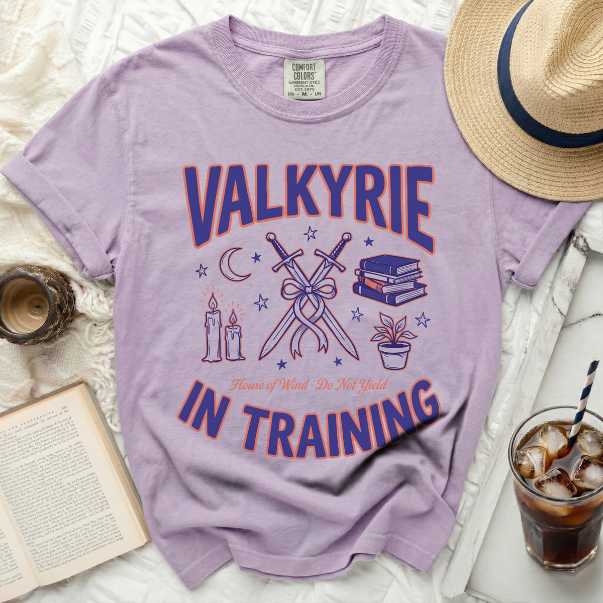 Lavender t-shirt with "Valkyrie in Training" and graphic designs.
