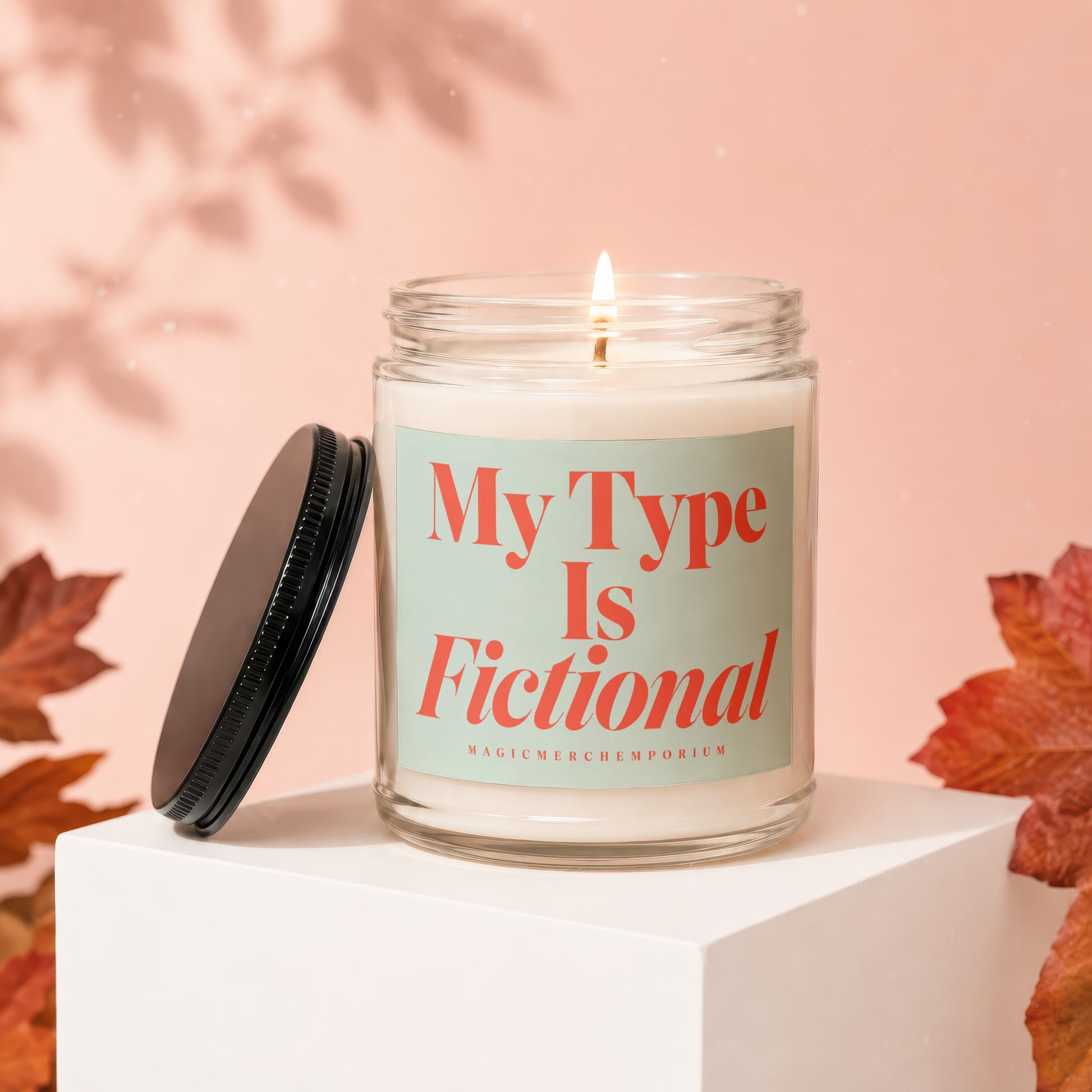 Candle in glass jar with "My Type Is Fictional" on label, lid off.