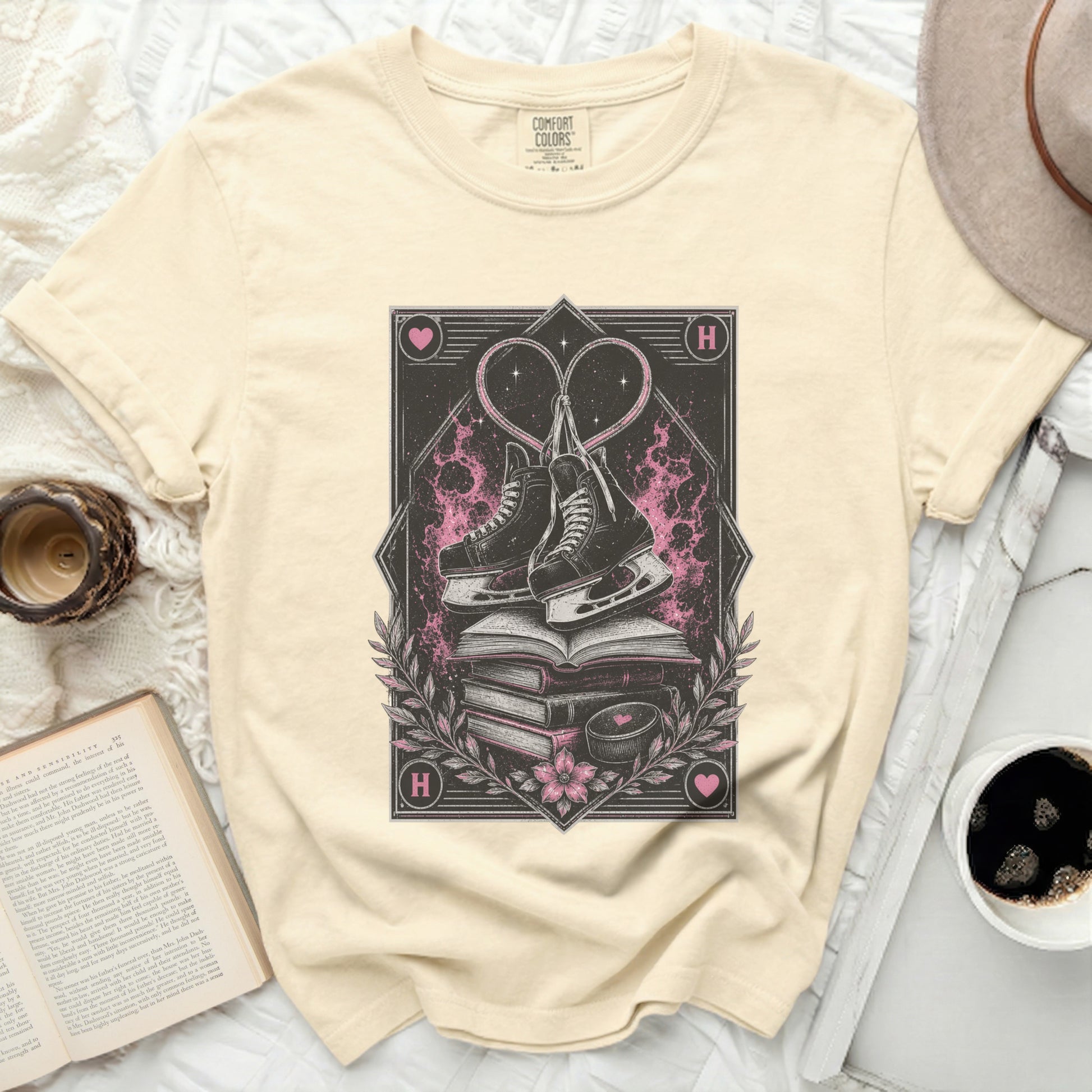 Ice skates on stacked books with heart design and "H" logo.