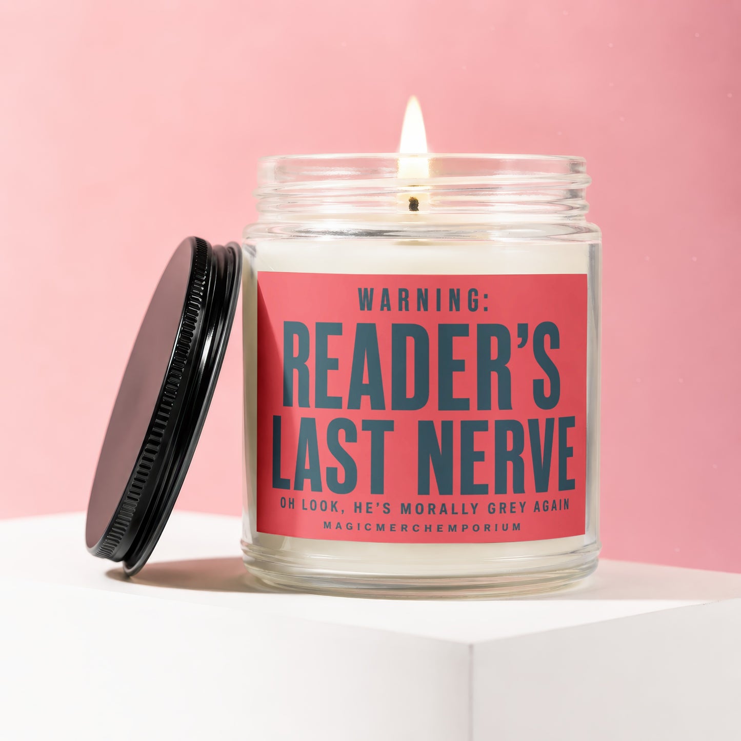 Candle with lid off, light on, reading "WARNING: READER'S LAST NERVE".