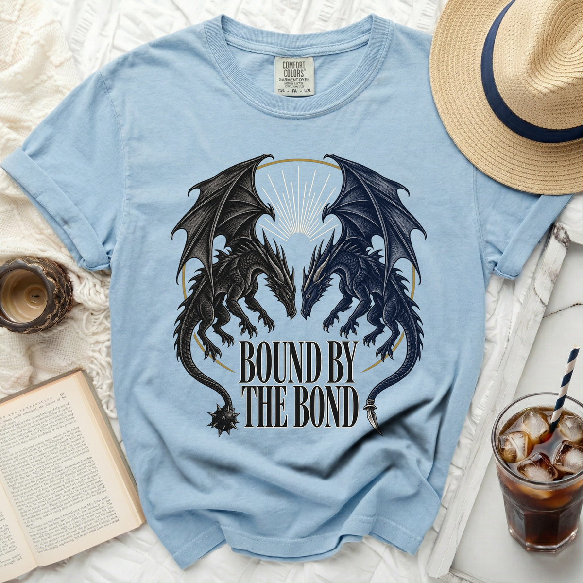 Light blue Comfort Colors t-shirt with "BOUND BY THE BOND" and two dragons graphic.
