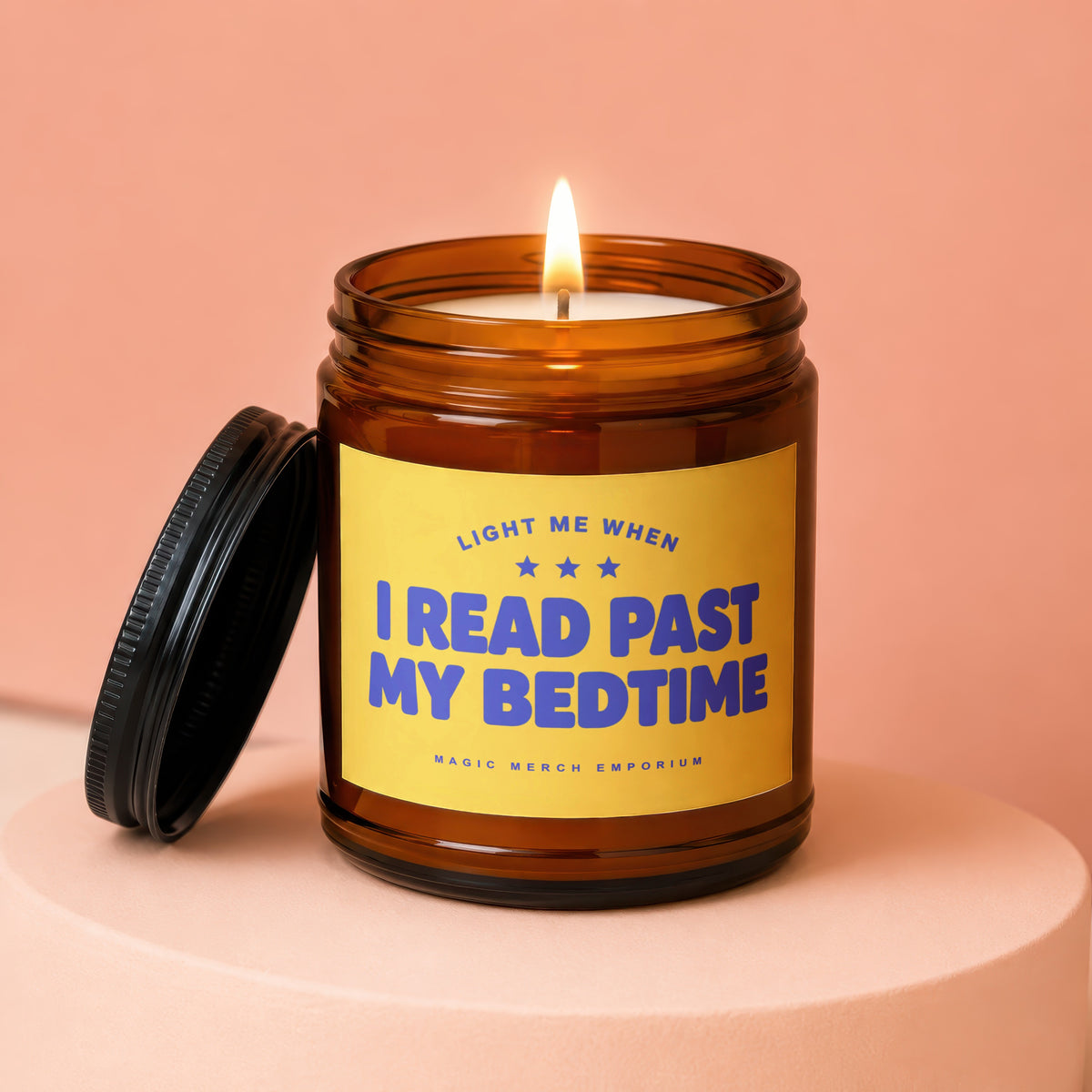 Amber jar candle with yellow label reading "Light Me When I Read Past My Bedtime".