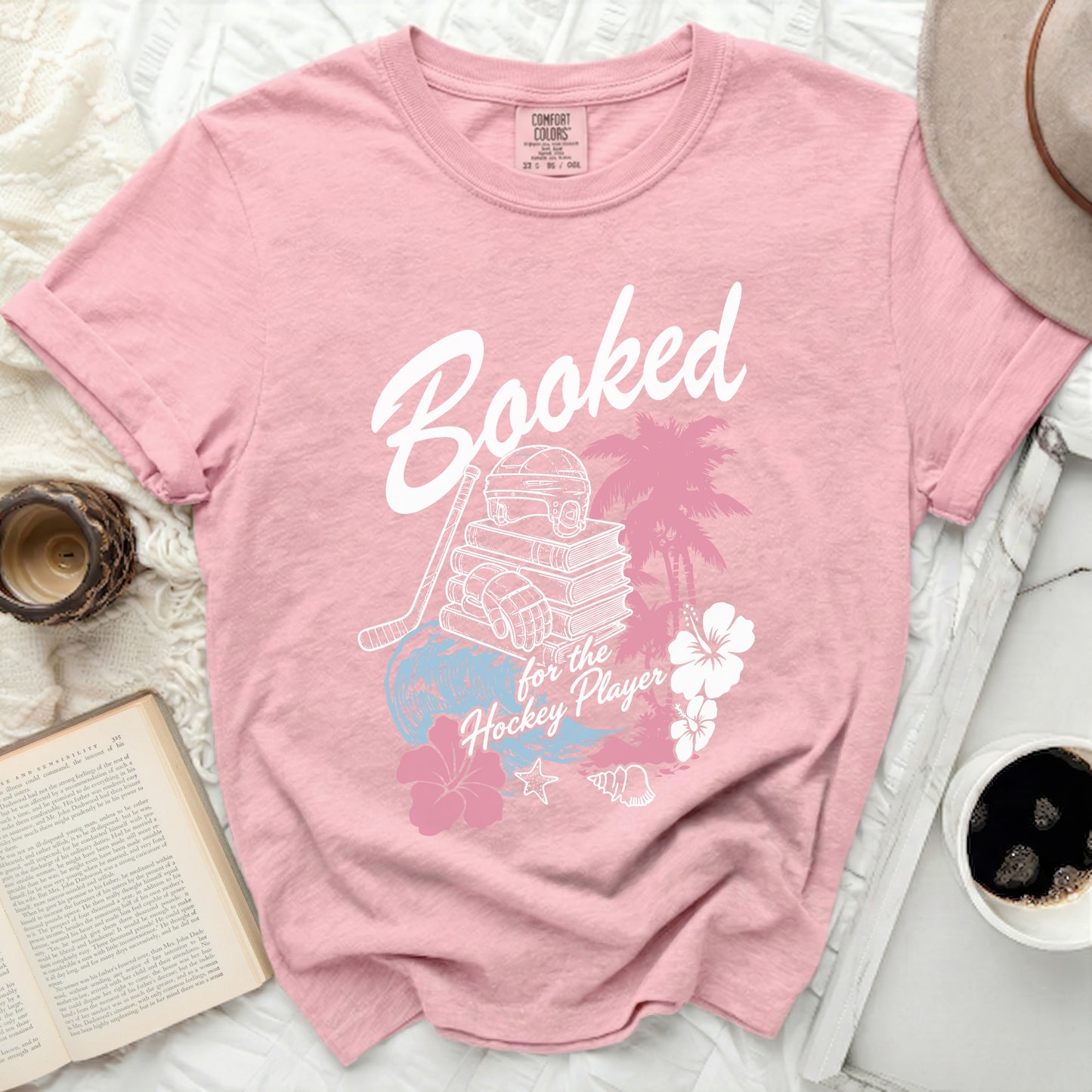 Pink t-shirt with "Booked for the Hockey Player" text and graphic.