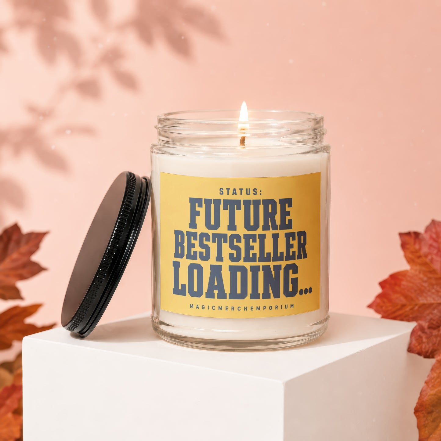 Candle with yellow label reading "STATUS: FUTURE BESTSELLER LOADING...".