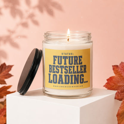 Candle with yellow label reading "STATUS: FUTURE BESTSELLER LOADING...".