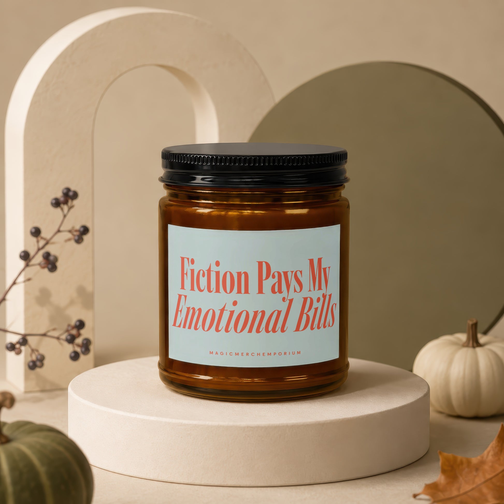 Amber jar candle with text "Fiction Pays My Emotional Bills" on a light blue label.