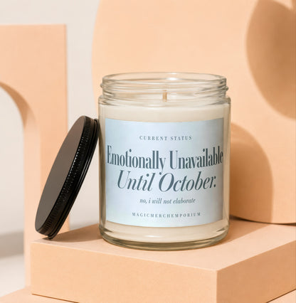 Glass candle with a black lid, reading "Emotionally Unavailable Until October."