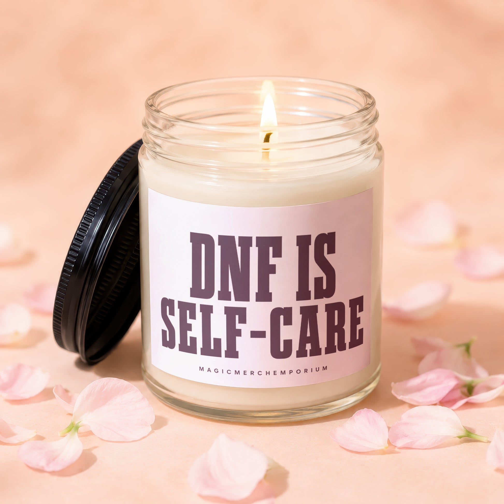 Jar candle with "DNF IS SELF-CARE" text and a lit wick surrounded by petals.