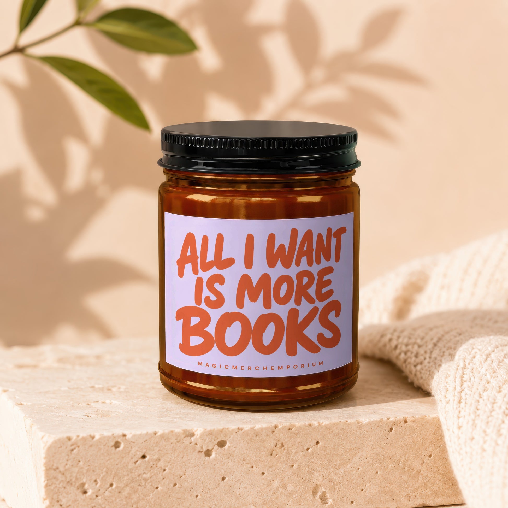 Amber glass candle with label reading "All I Want Is More Books"
