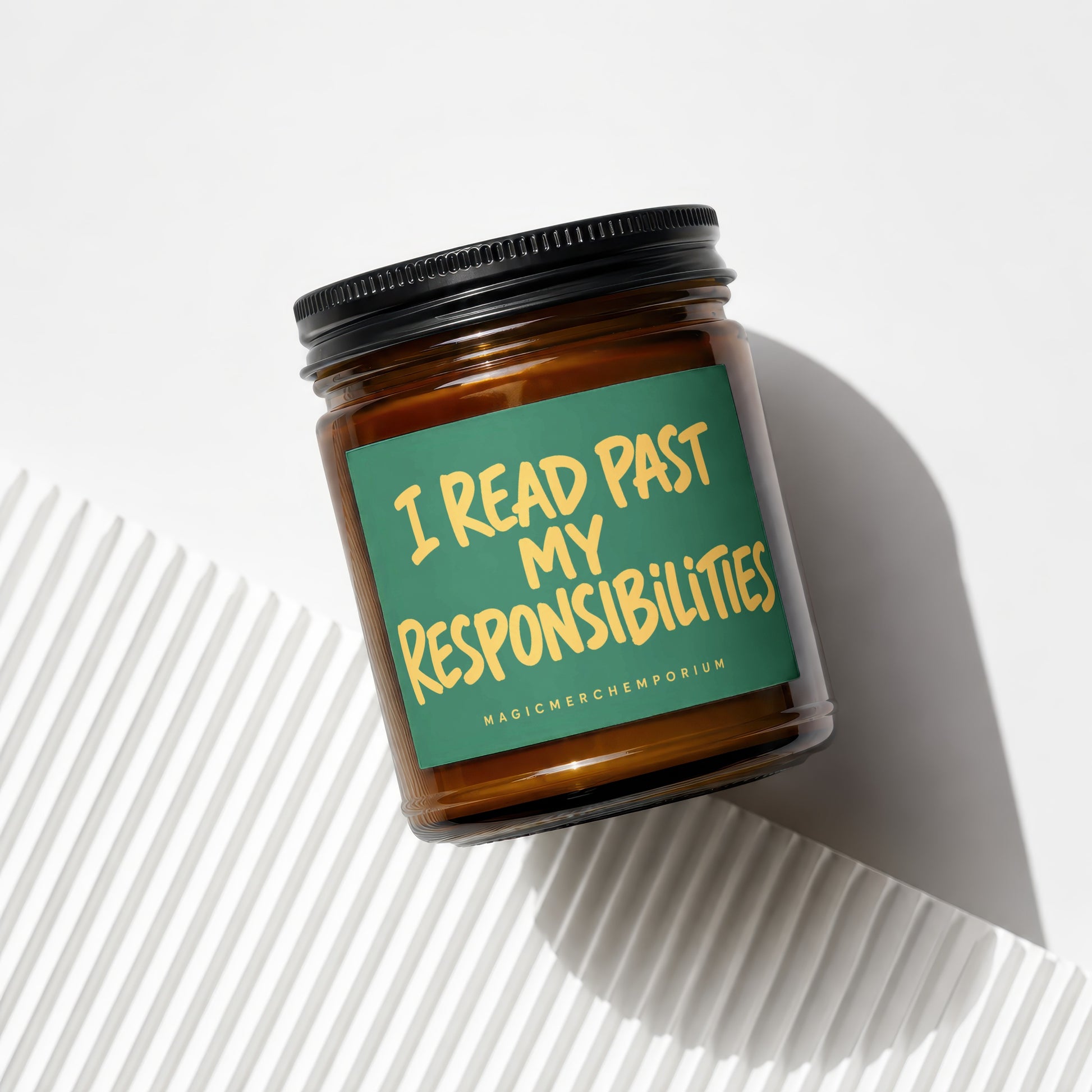 Amber candle with green label reading "I READ PAST MY RESPONSIBILITIES".