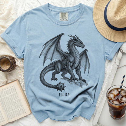 Light blue t-shirt with a detailed dragon graphic and the word TAIRN.