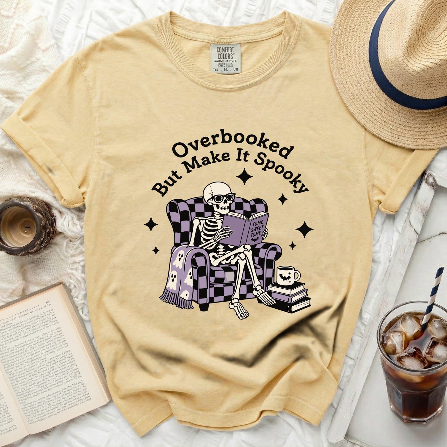 Skeleton reading "Tome Sweet Tome" on "Overbooked But Make It Spooky" shirt.