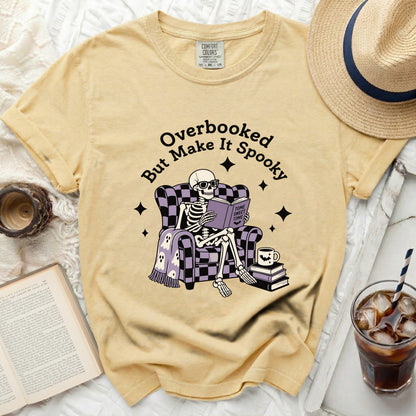 Skeleton reading "Tome Sweet Tome" on "Overbooked But Make It Spooky" shirt.