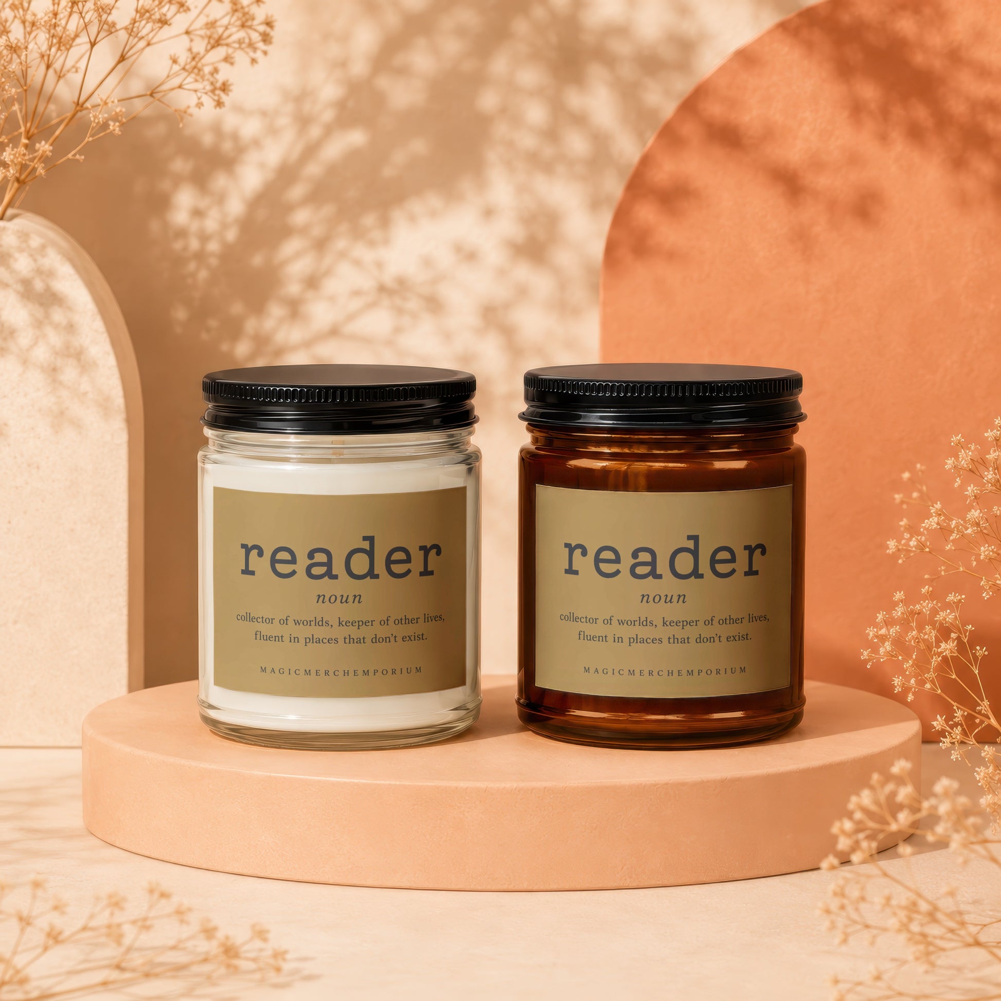 Two candles with "reader" definition labels on pedestals with dried flowers.