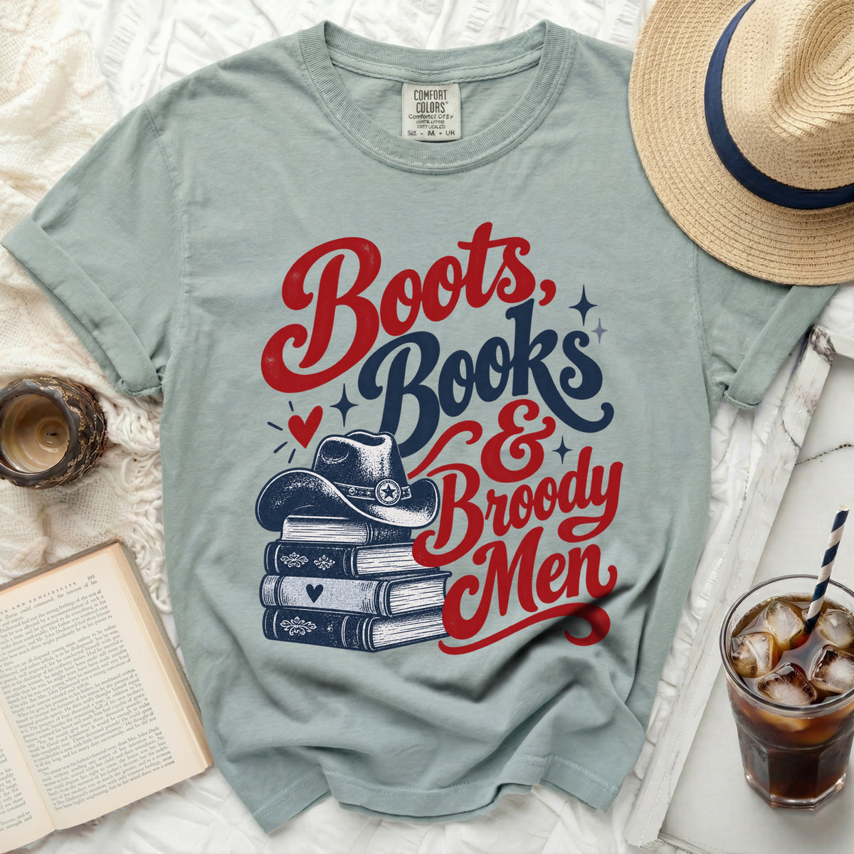 Light blue t-shirt with "Boots, Books & Broody Men" text and cowboy hat.