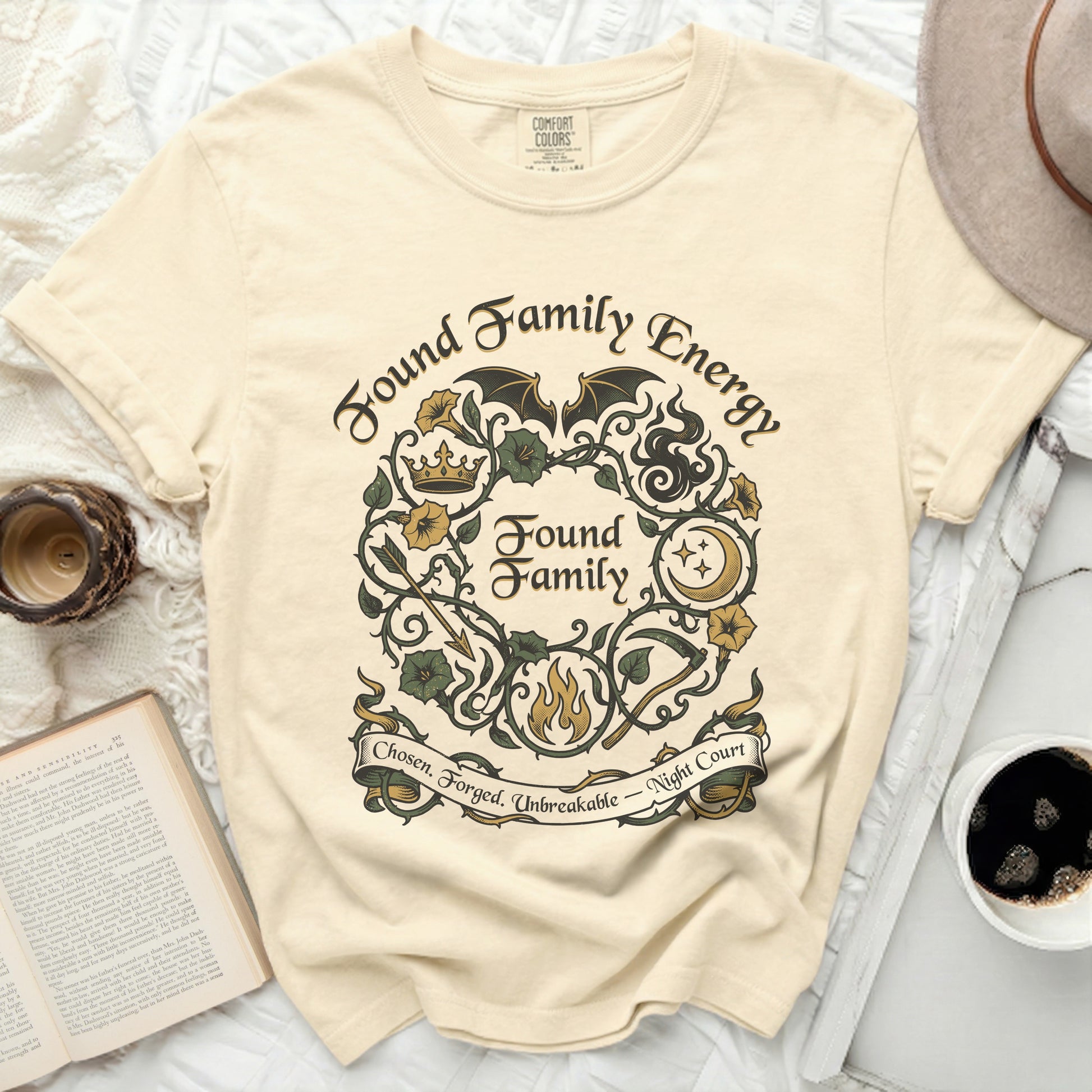 Cream t-shirt with "Found Family Energy" text and wreath design.