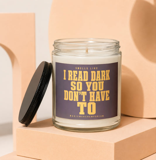 Glass candle with label reading "Smells like I read dark so you don't have to".