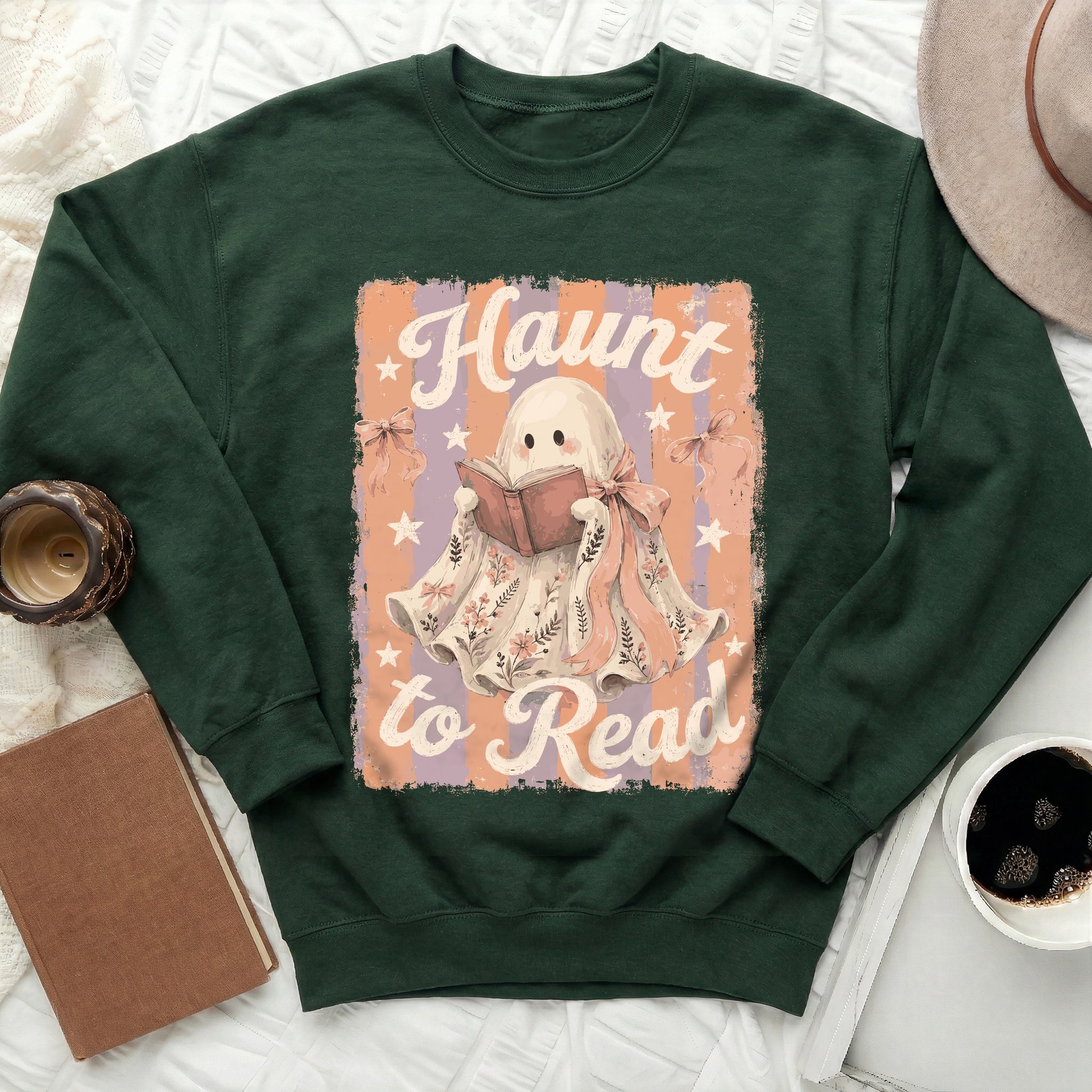 Green sweatshirt with ghost reading a book and text "Haunt to Read."
