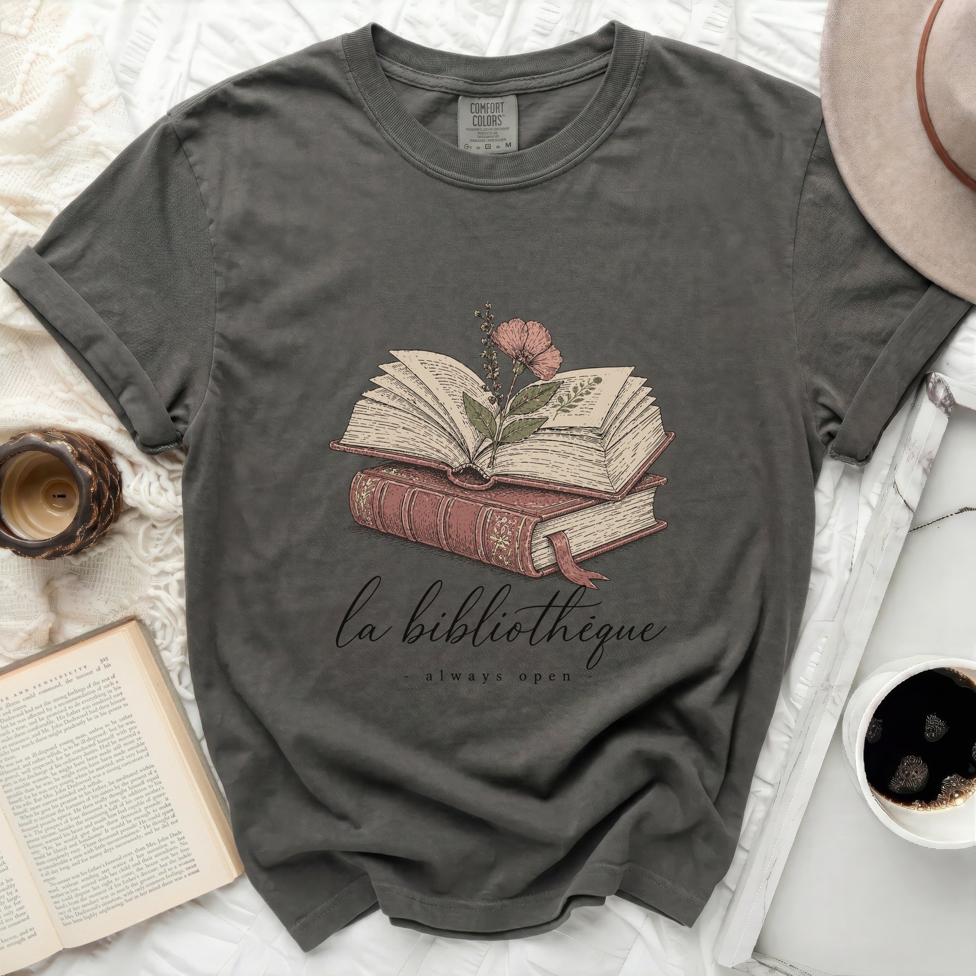 Dark grey t-shirt with "la bibliotheque - always open" and stacked books graphic.