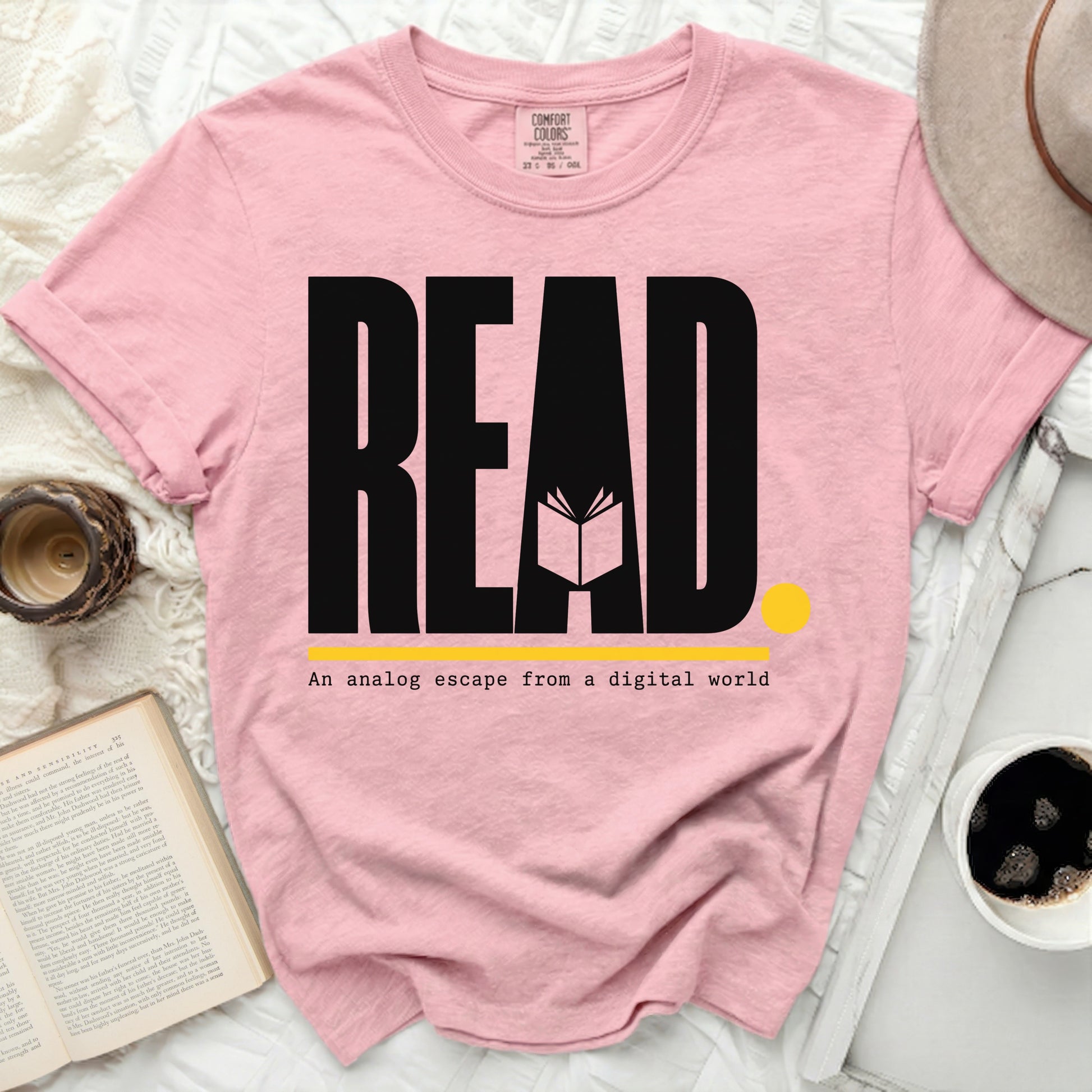 Pink t-shirt with "READ An analog escape from a digital world" text.